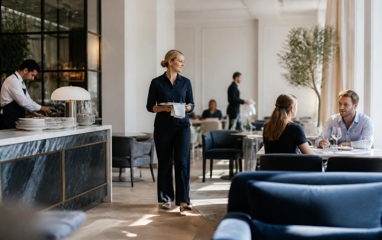 Staff and guests in a modern restaurant setting